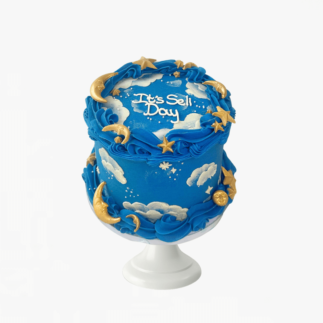 Blue cake with gold stars and moons on a white background - children's birthday cakes Sydney