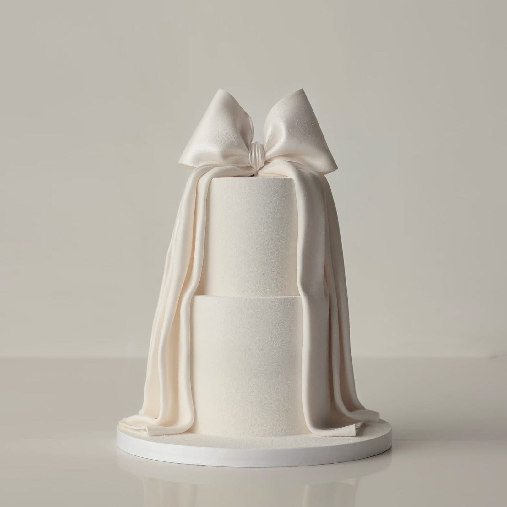 Satin buttercream cake with tall silhouette, ribbon details and vintage piping – birthday cakes Sydney