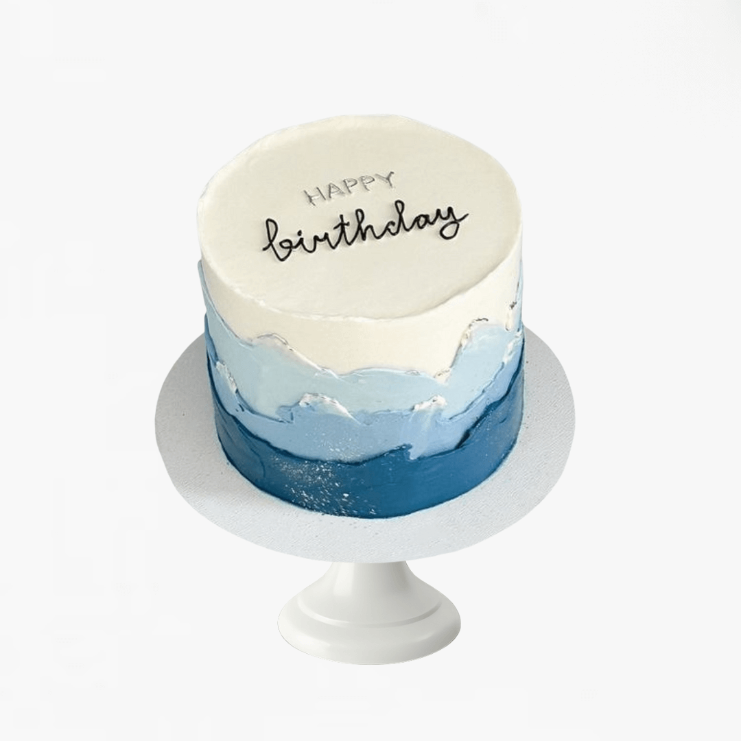 Small birthday cake with blue and white frosting on a white stand - men's birthday cakes Sydney