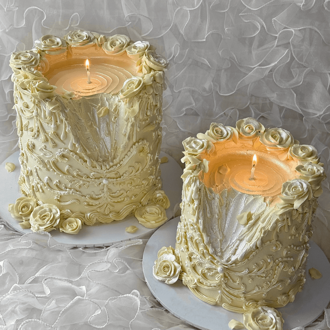 Two ornate candle holders with floral designs on a textured white background