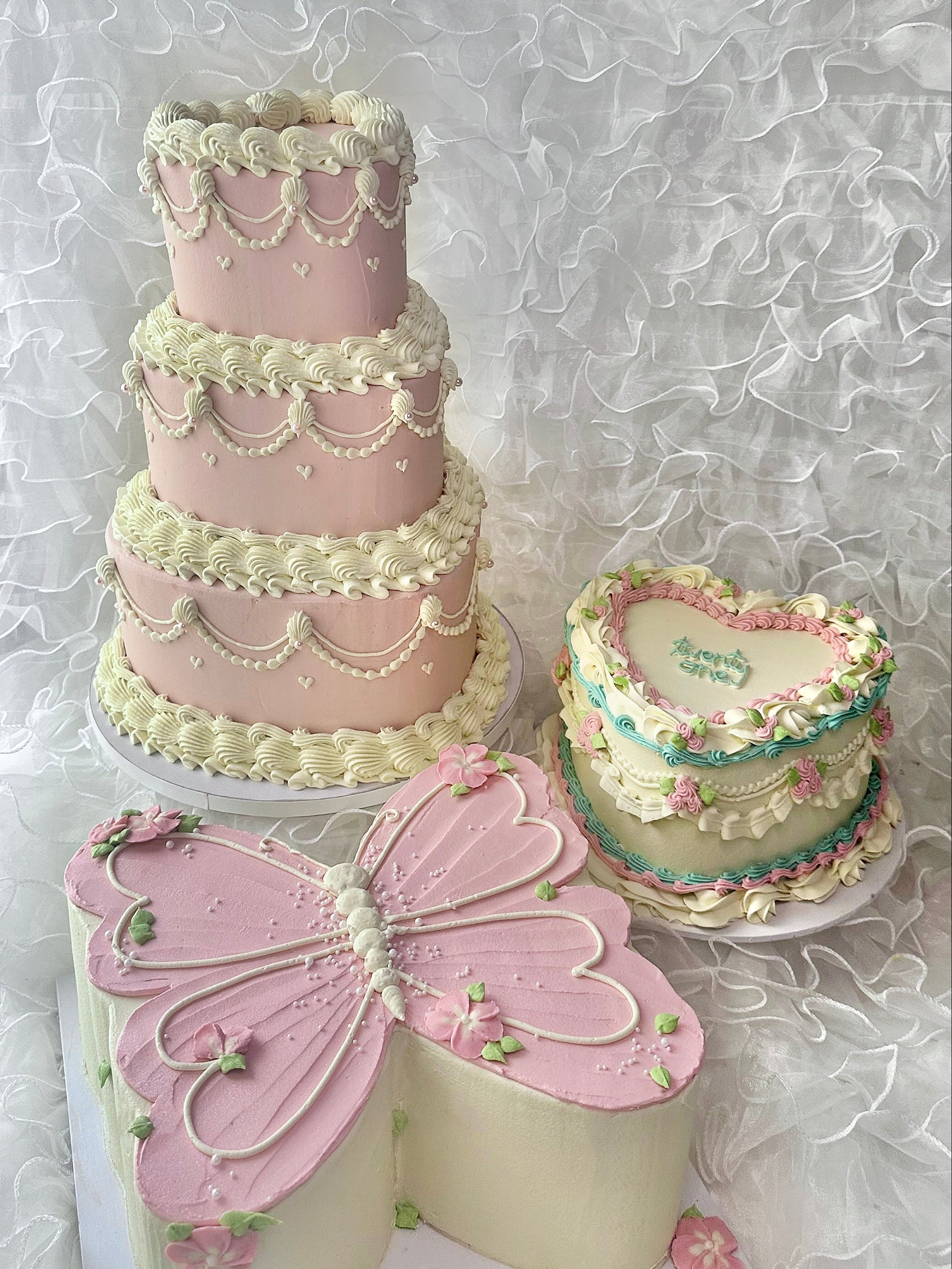 Three decorative cakes with intricate designs 