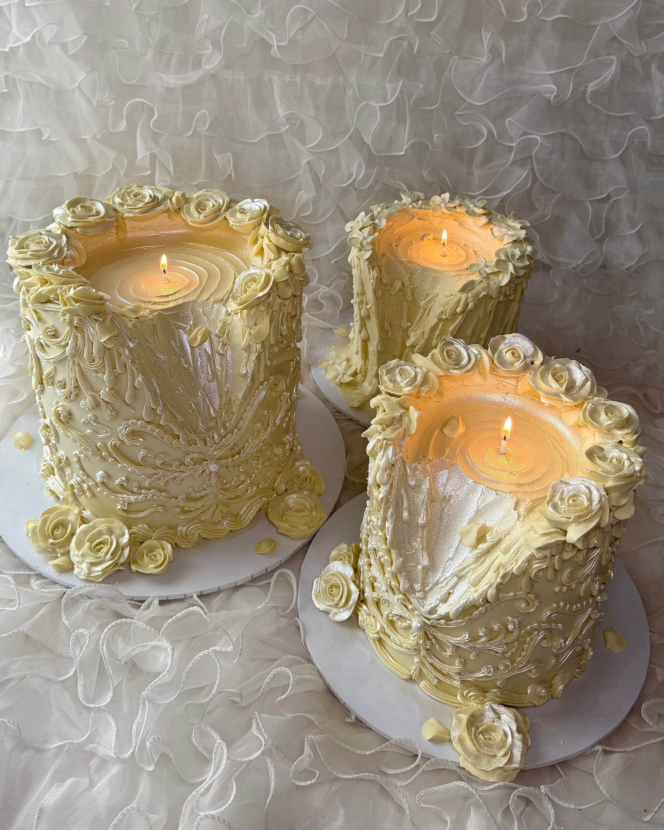 Three ornate candle cakes with a pearl finish 