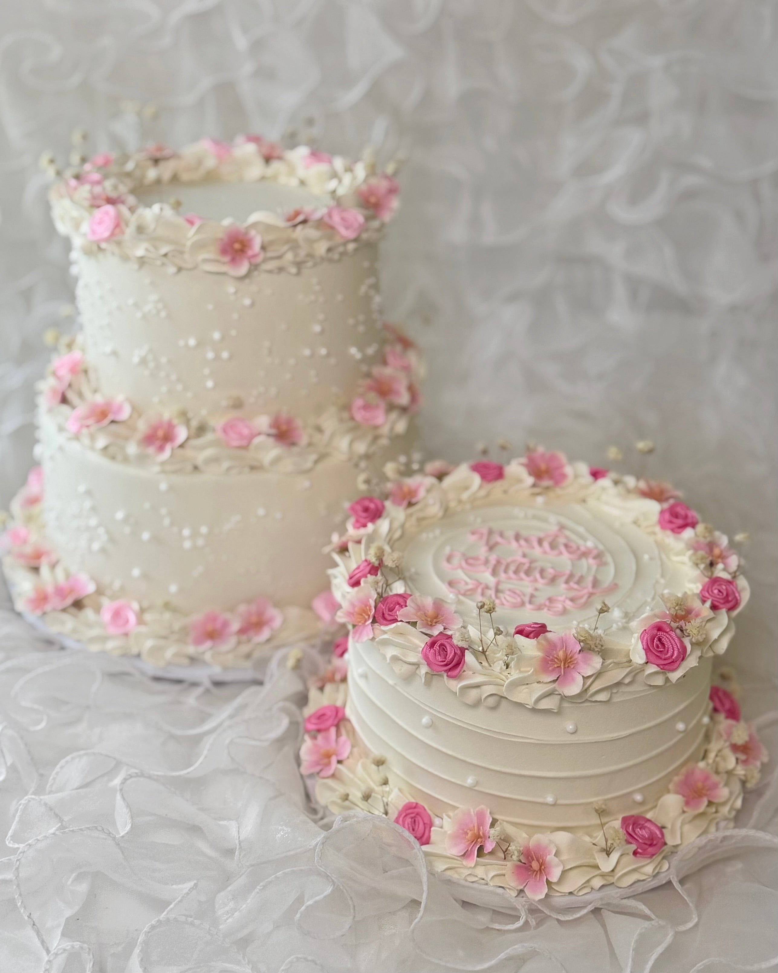 White cake with pink flowers