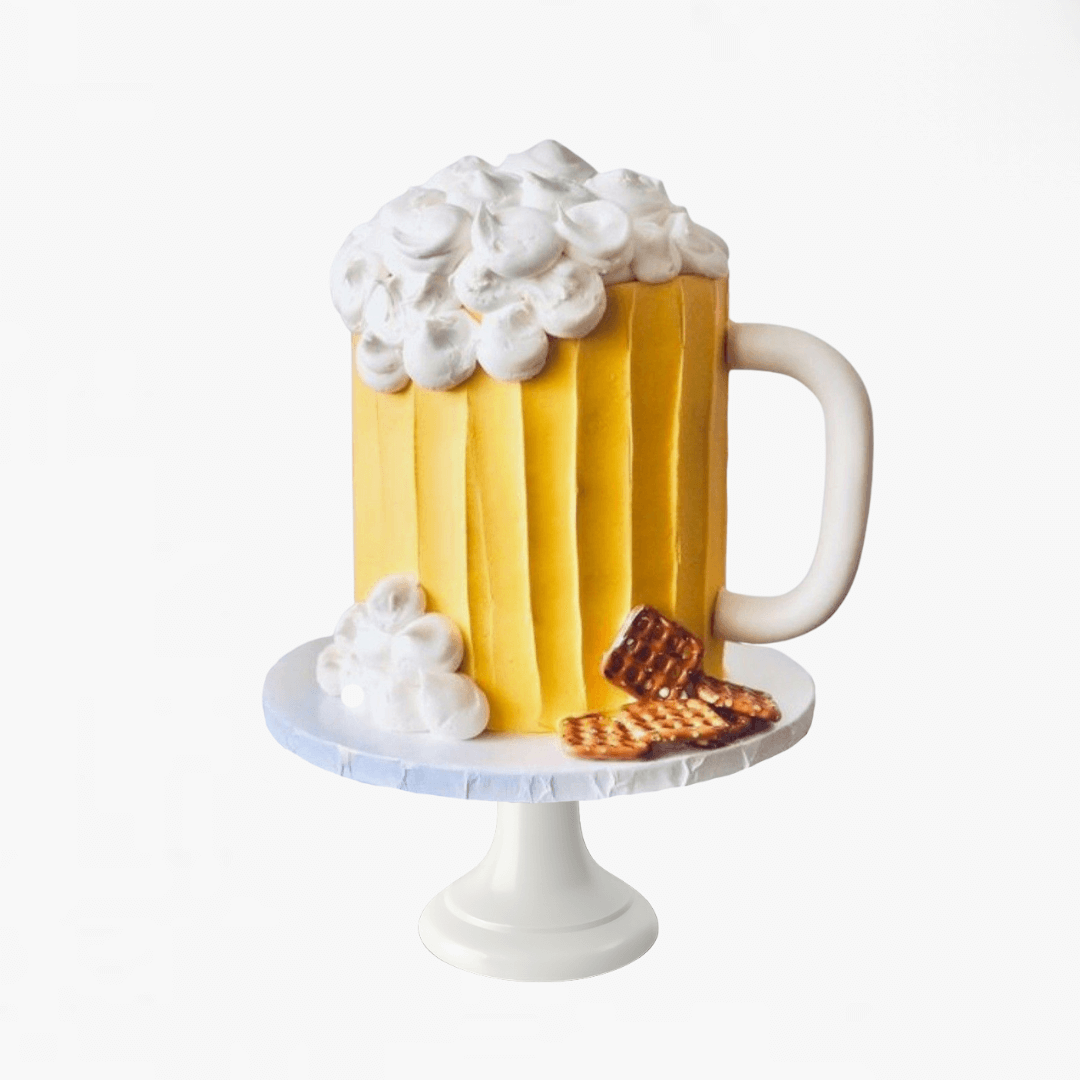 Cake designed to look like a mug of beer with foam and a cookie on a white background - men's birthday cakes 