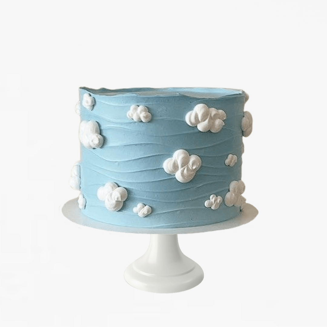 Blue cake with white cloud decorations on a white stand - children's birthday cake 