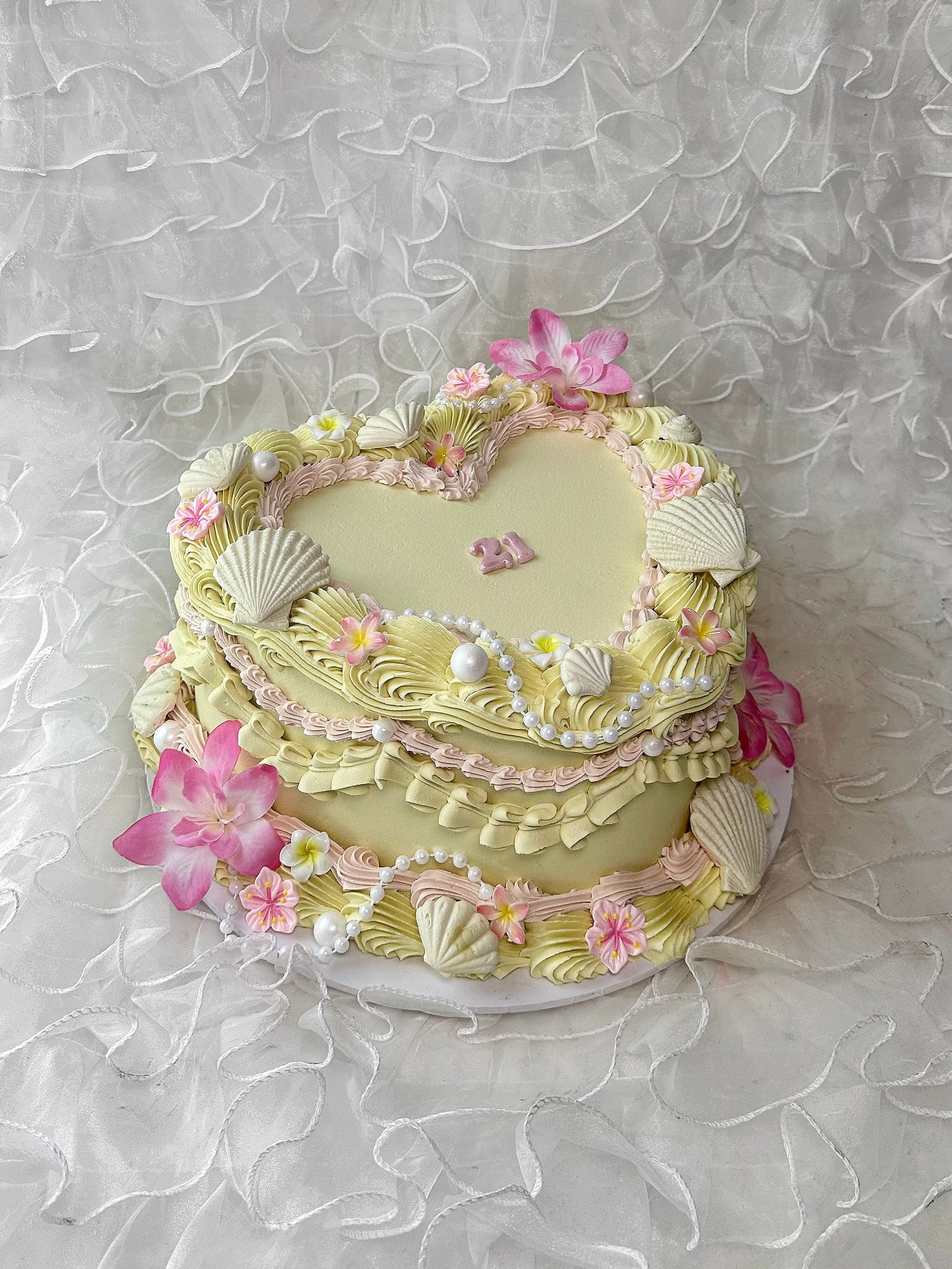 A Hawaiian cake with shell and flower designs 