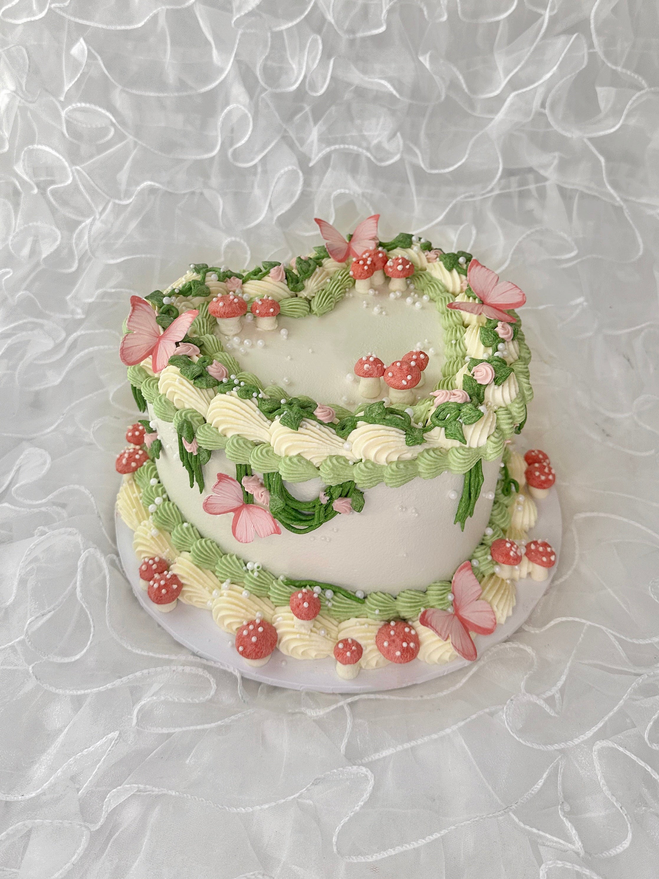 Fairy garden cake with green and pink icing and pink mushrooms 