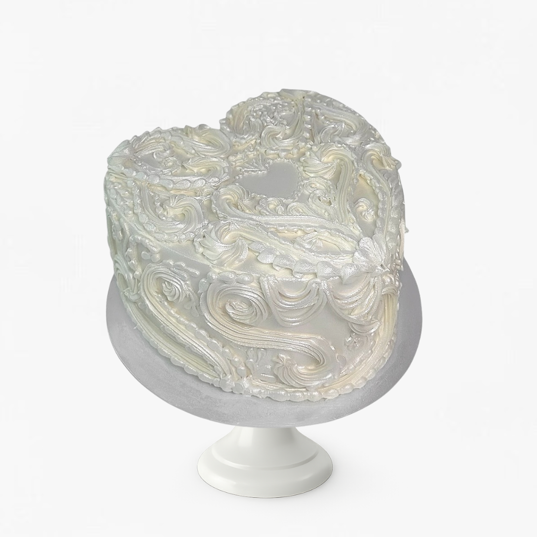 Decorative cake with intricate design on a white stand against a white background - gender reveal cakes Sydney 