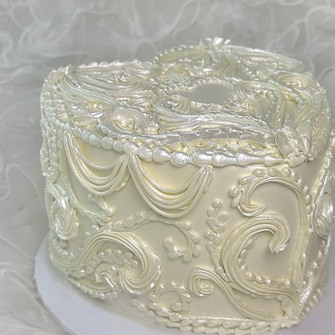 Decorative cake with intricate white frosting patterns - gender reveal cakes Sydney 