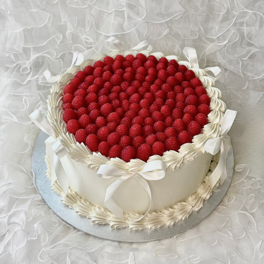 Cake with raspberrys berries and white frosting - wedding cakes Sydney 