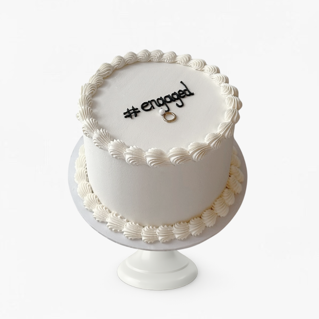 White cake with 'engaged' decoration - engagement cakes Sydney 