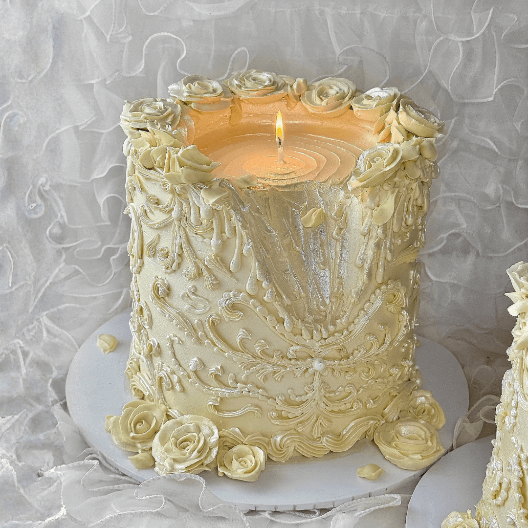 Decorative candle with floral designs on a textured white background - custom cakes Sydney 