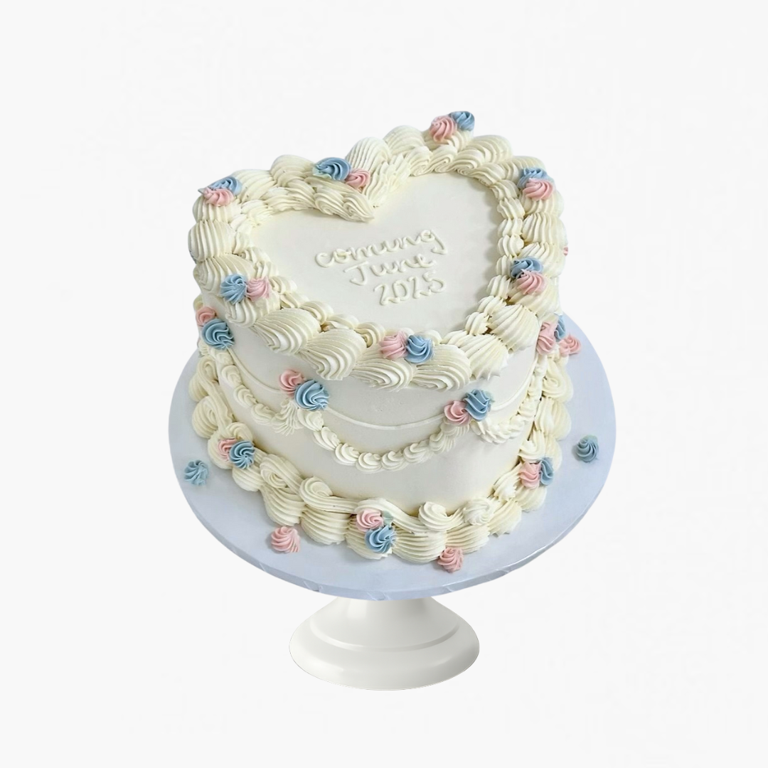 heart-shaped gender reveal cake with pink and blue rosettes –  gender reveal cakes Sydney